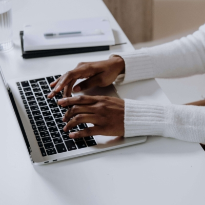 Someone typing on a laptop